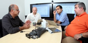Habib Najm, Bert Debusschere, Khachik Sargsyan, and Cosmin Safta compare observational data with climate land model simulation results in a weekly meeting for the ACME UQ project. (Photo by Dino Vournas) 