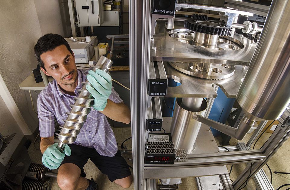 Ivan Ermanoski works on a room-temperature prototype of the packed particle bed reactor for solar-thermochemical hydrogen production. (Photo by Randy Montoya)