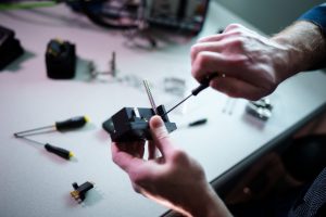<strong>Sandia National Laboratories systems engineer Robert Petterborg assembles a newly designed cable connector that’s simple to use — so simple, he says it’s impossible to use wrong.</strong> (Photo by Craig Fritz) Click on the thumbnail for a high-resolution image.
