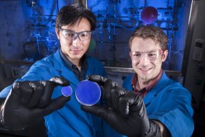 Sandia National Laboratories researcher Patrick Feng, left, and Former Sandian Joey Carlson, right, hold Organic Glass Scintillators they helped create to detect radioactive materials.