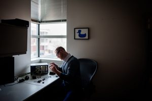 <strong>Sandia National Laboratories engineer Robert Petterborg assembles a newly designed cable connector in his office. Robert designed the cable in his spare time with the help of colleagues across the Laboratories. </strong>(Photo by Craig Fritz) Click on the thumbnail for a high-resolution image.. 