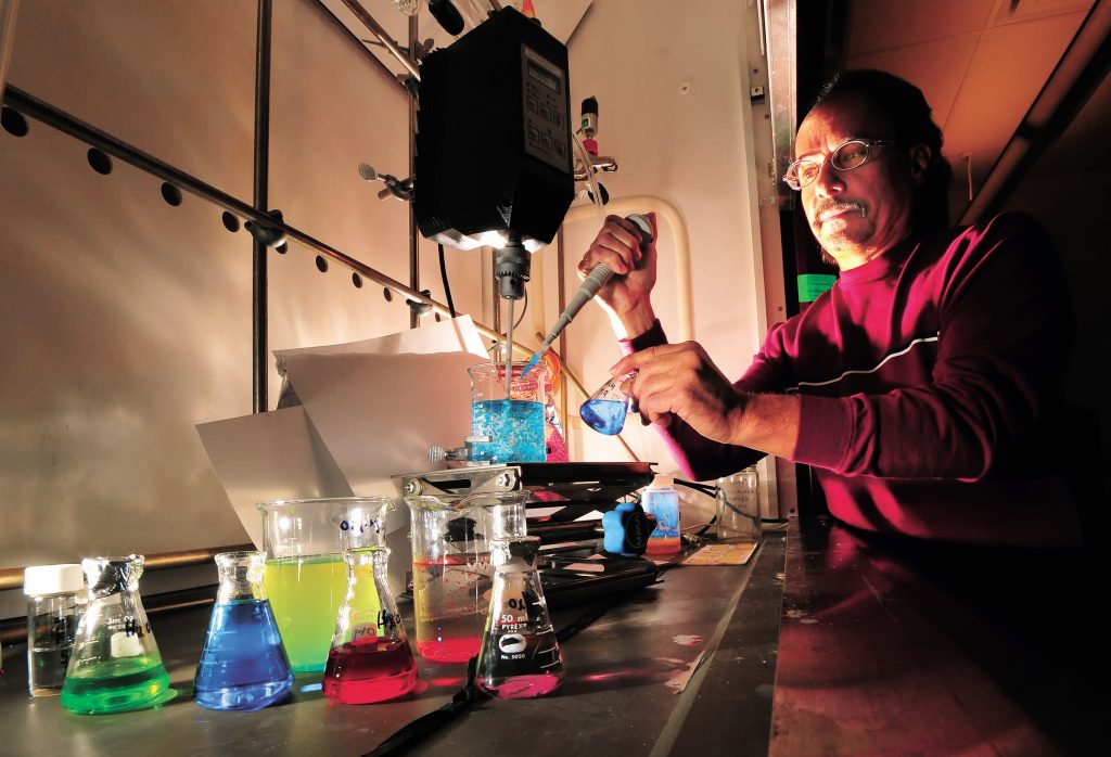 Duane Schneider demonstrates a microencapsulation process that results in a chemical being encapsulated in a polymer shell. Familiar uses for microencapsulation include scratch-and-sniff perfume ads in magazines, time-release medications, and carbonless copy paper. Duane is working with a local business to develop a microencapsulation process for a cosmetics product (Photo by Randy Montoya).