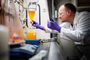 <strong>Sandia National Laboratories chemist Chad Staiger uses a separatory funnel to remove byproduct from the synthesis of a molecule.</strong> (Photo by Craig Fritz) Click on the thumbnail for a high-resolution image.