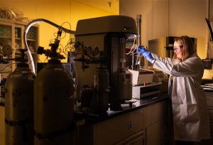 <strong>Melissa Mills prepares sample tubes for degassing by heating the sample to remove anything in the pores. She will place the tubes in an instrument with the liquid nitrogen bath to measure gas adsorption and gather surface area and pore size distribution data.</strong> (Photo by Craig Fritz) Click on the thumbnail for a high-resolution image.