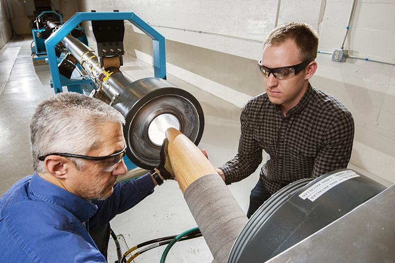 Mech Shock personnel prepare to load a test projectile into the breech of the 6-inch Gas Gun to be fired into a target at 1140 ft/s.