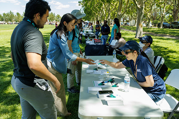 Interns at Sandia Intern Welcome Event receiving information at a booth