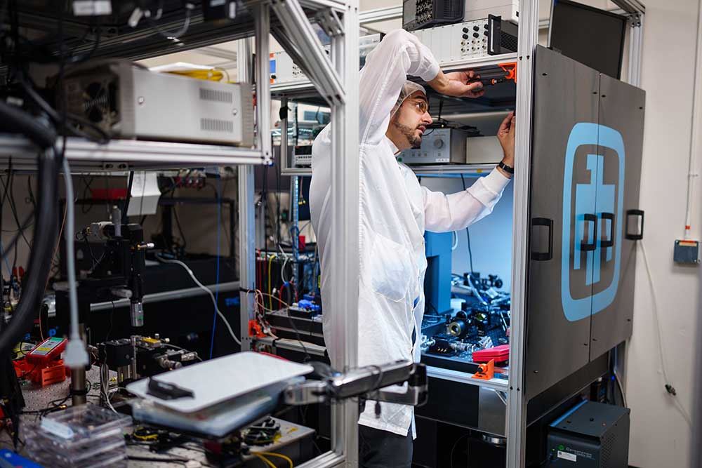 QUANTUM ADVANCEMENT — Truman Fellow Sam Peana constructs a laser enclosure for a confocal time-correlated single photon counting microscope. This microscope will be used to measure the quantum properties of single photon emitters that will be produced in the Microsystems Engineering, Science and Applications facility. (Photo by Craig Fritz)