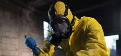 Man in hazmat suit with biohazard material