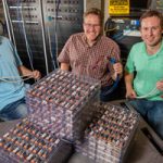 AMPS cofounders and Sandia engineer work on flat of batteries