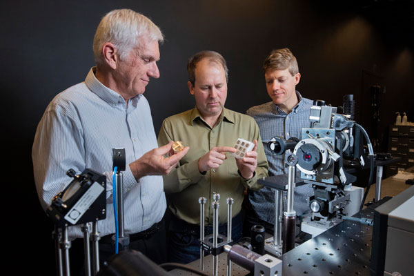 scientists evaluate metal sample with tabletop laser system