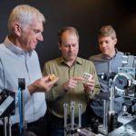 scientists evaluate metal sample with tabletop laser system