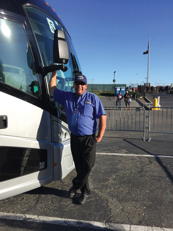 Brian Olson in front of bus