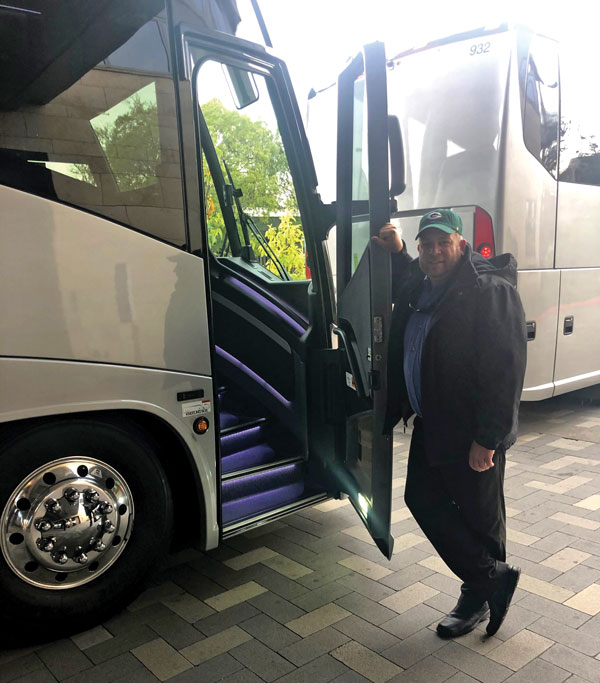 Brian Olson in front of bus