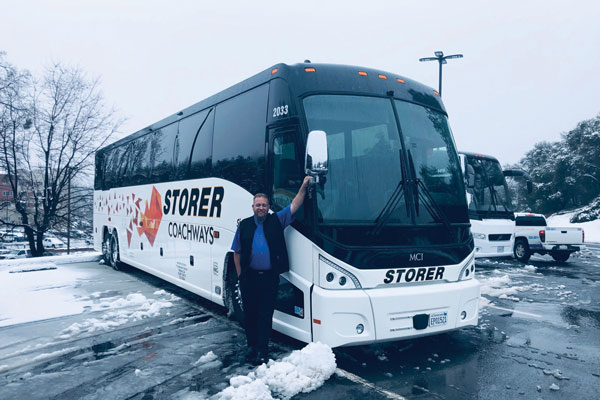 Brian Olson in front of bus