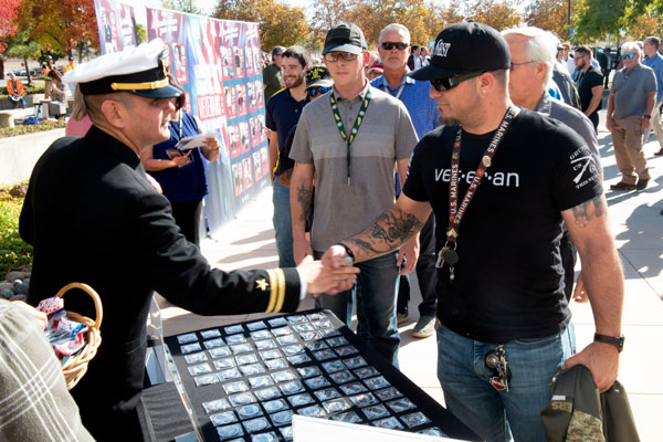 officer hands out veteran coins