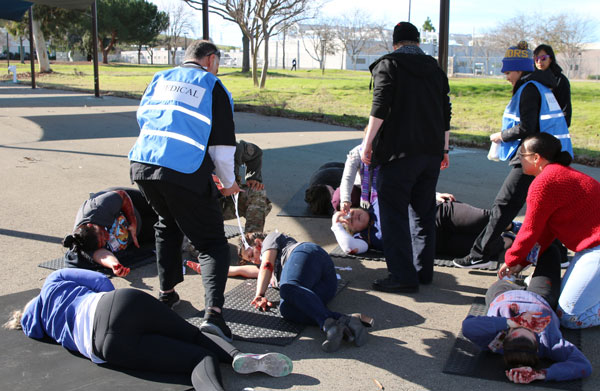 Medical personnel examine exercise victims