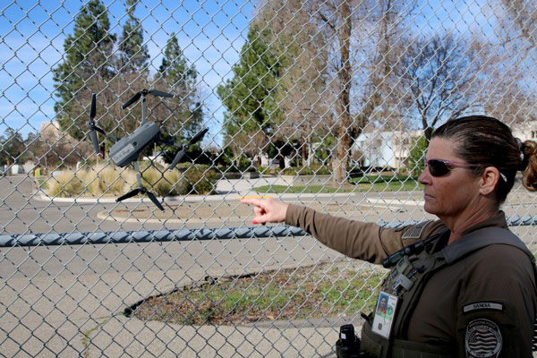 officer points out drone crash location