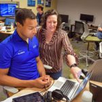 Tommie Kuykendall talks to intern in computer lab