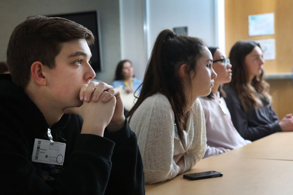 students listen to presentation