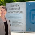 Dori in front of the Sandia sign at the Albuquerque campus