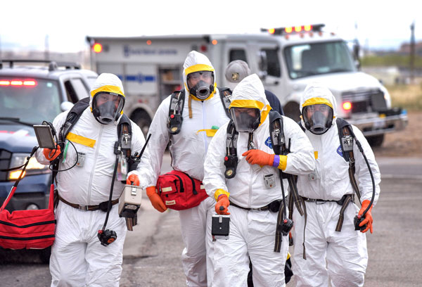 emergency responders dressed in hazardous material protection gear