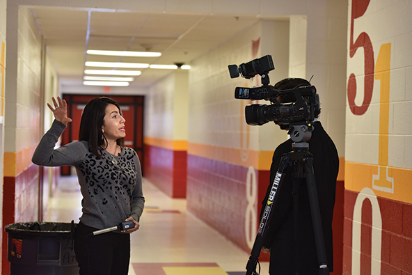 Jessica Montoya-Valerio speaks with a local news reporter about the importance of the program.