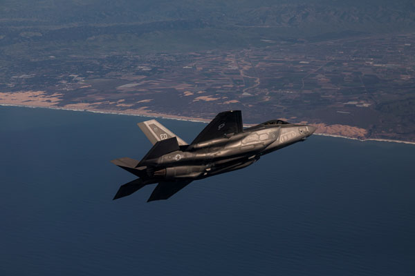 F-35A Lightning II jet fighter in flight over coastline