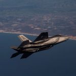 F-35A Lightning II jet fighter in flight over coastline