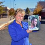 Theresa Rolfe holds a photo of her son Ted Benoit