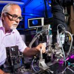Chemist David Chandler, a recent Labs Fellow, examines a piece of technology