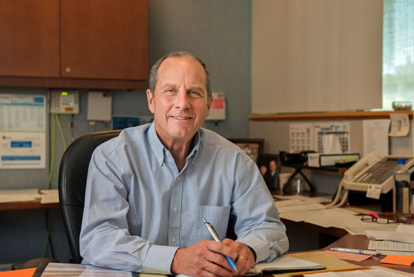 Steve Girrens sits behind his desk