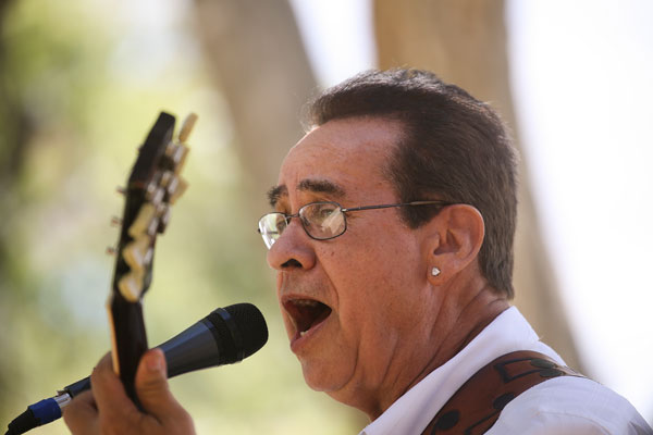 Roberto Griego playing guitar and singing