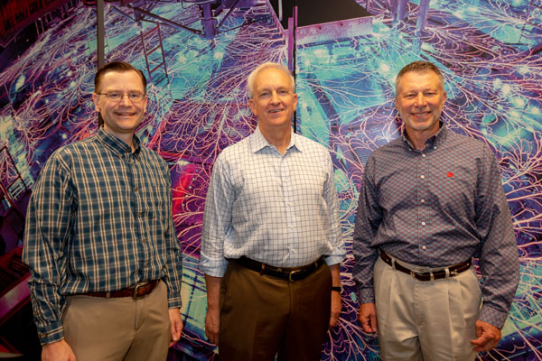 Huizenga and Sandia executives pose for photo during tour