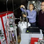 researchers work on lab equipment for hydrogen-powered transportation storage