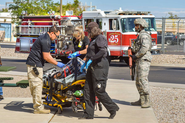 emergency responders assist an injured victim during an exercise