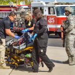 emergency responders assist an injured victim during an exercise