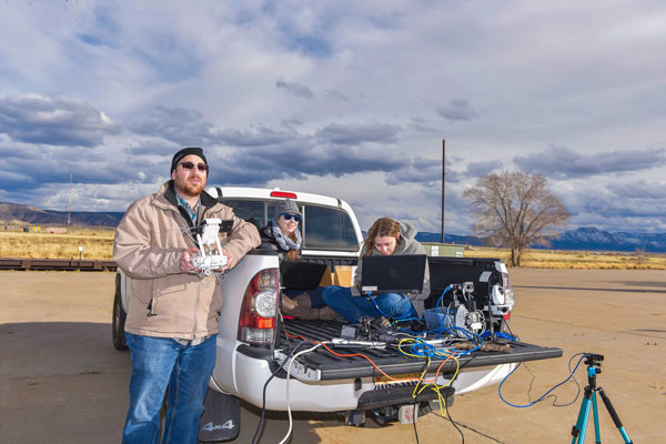 researchers on ground testing UAS components