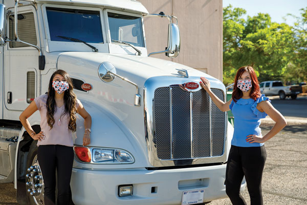 researchers stand in front of MGT prototype, wearing masks and socially distancing