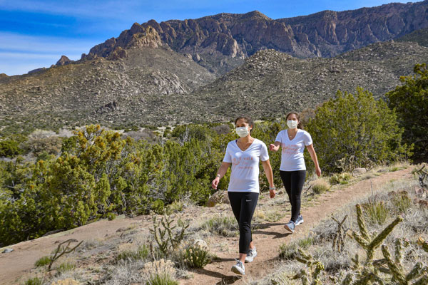 two people in masks participate in virtual walk