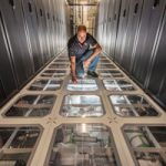 David J. Martinez examines the cooling system at Sandia’s supercomputing center