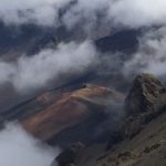 view of mountain tops shrouded in clouds