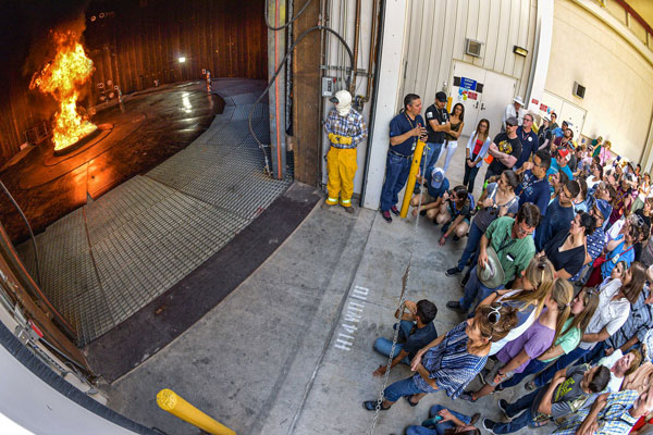 group gathers outside warehouse to view combustion experiment