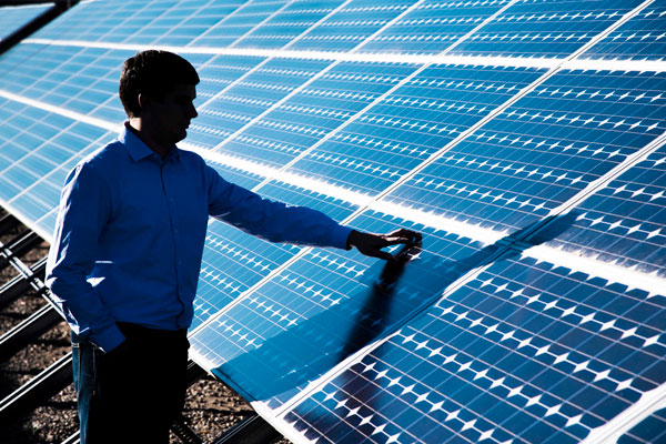 engineer examines solar panel