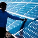 engineer examines solar panel