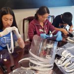 Helena Jin and her children assemble face shields
