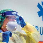 health care worker wearing respirator mask and other PPE