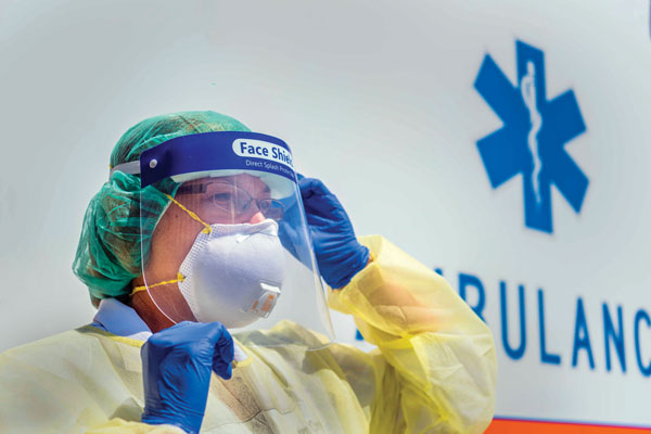 health care worker wearing respirator mask and other PPE