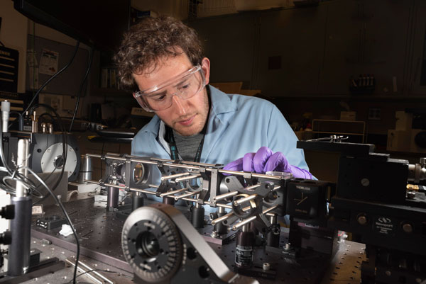 optical scientist works on microsopy equipment