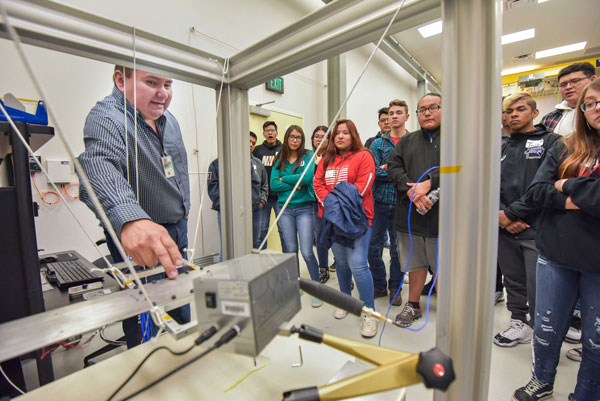 scientist demonstrates equipment use for students