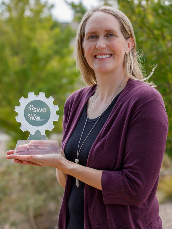 Christina Beppler holding her SWE award